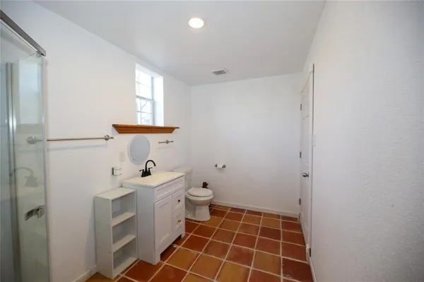 a bathroom with a sink toilet and shower