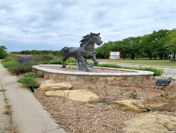 a view of a swimming pool with a yard and sitting area