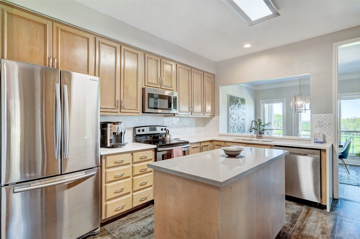 16 Tournament Way The Hills, TX 78738 - Photo 12 of 40 a kitchen with a refrigerator stove and microwave