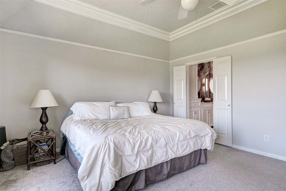 16 Tournament Way The Hills, TX 78738 - Photo 17 of 40 a bedroom with a bed and a lamp on table