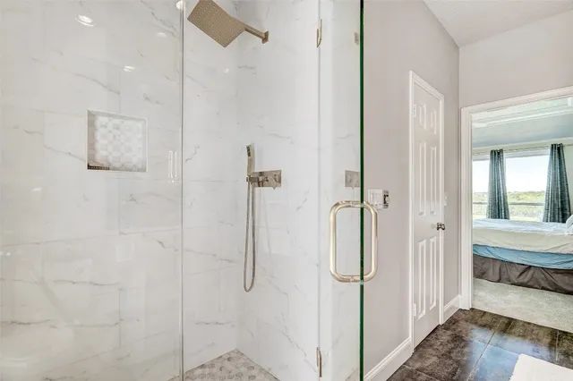a bathroom with a glass shower door