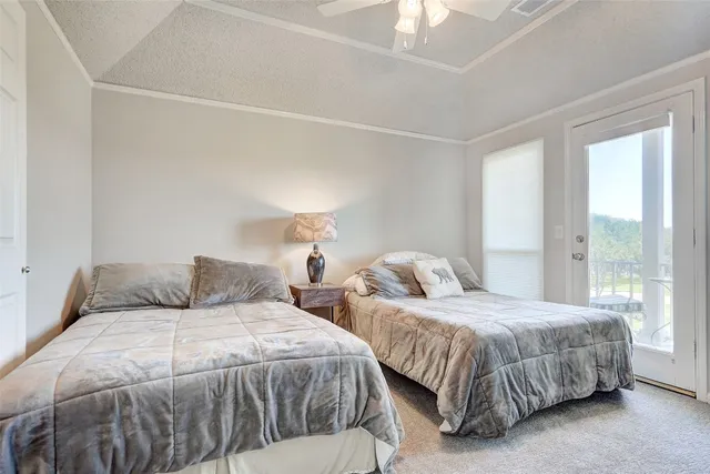 a bedroom with two beds and a large window