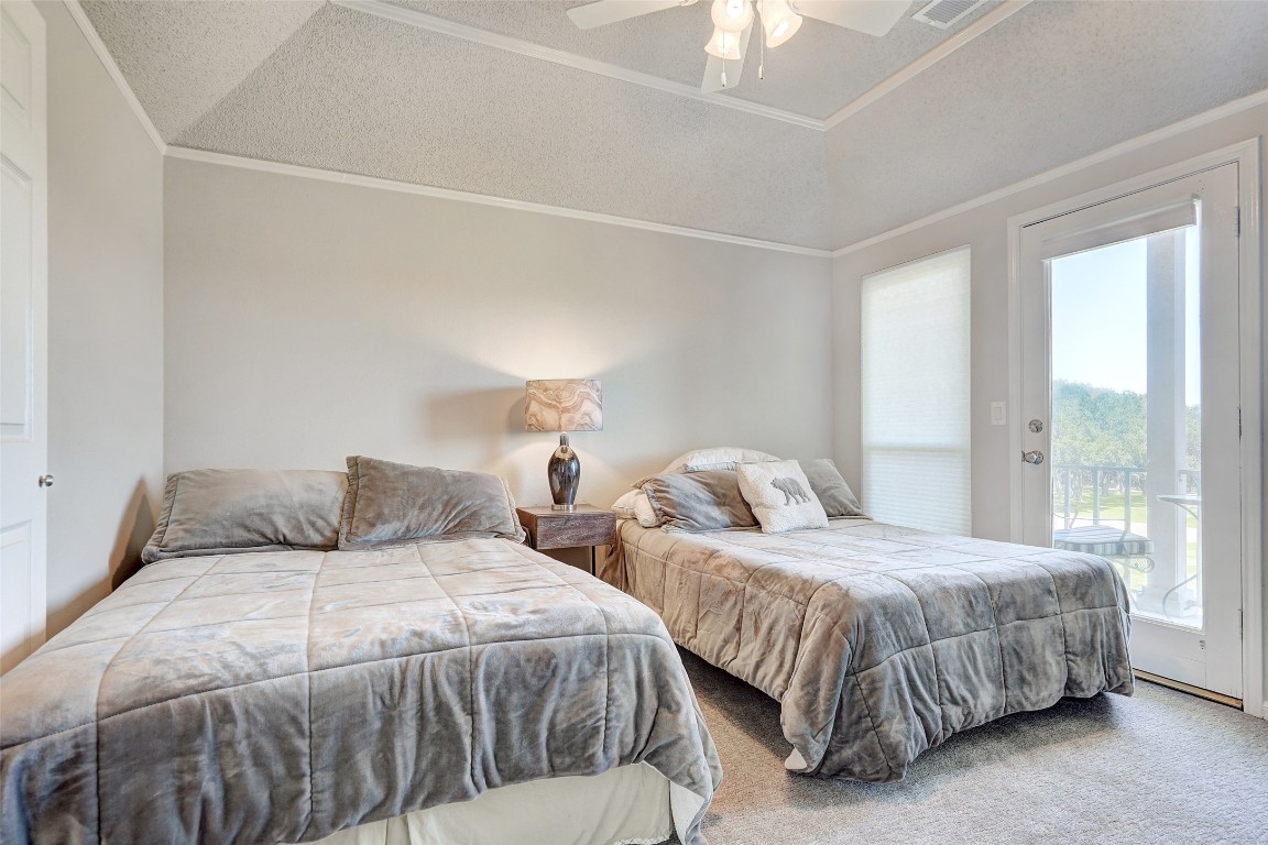 16 Tournament Way The Hills, TX 78738 - Photo 20 of 40 a bedroom with two beds and a large window