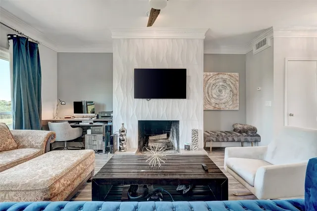 a living room with furniture a fireplace and a flat screen tv