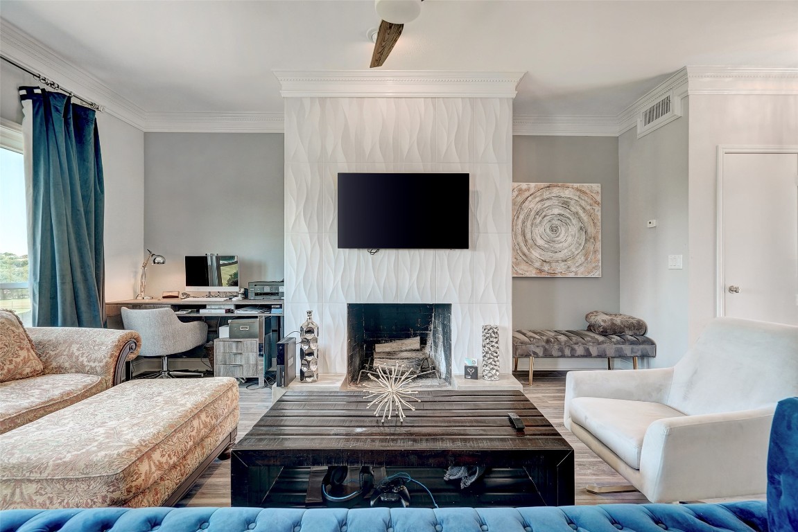 16 Tournament Way The Hills, TX 78738 - Photo 2 of 40 a living room with furniture a fireplace and a flat screen tv