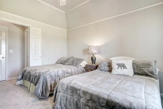 a bedroom with two bed and a lamp