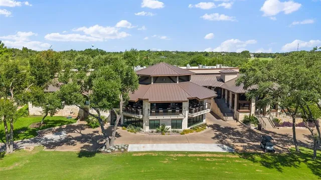 an aerial view of a house with swimming pool and garden
