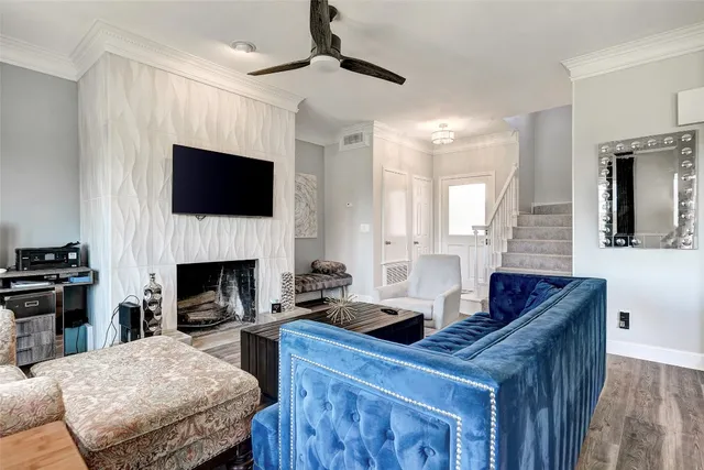 a living room with furniture a fireplace and a flat screen tv