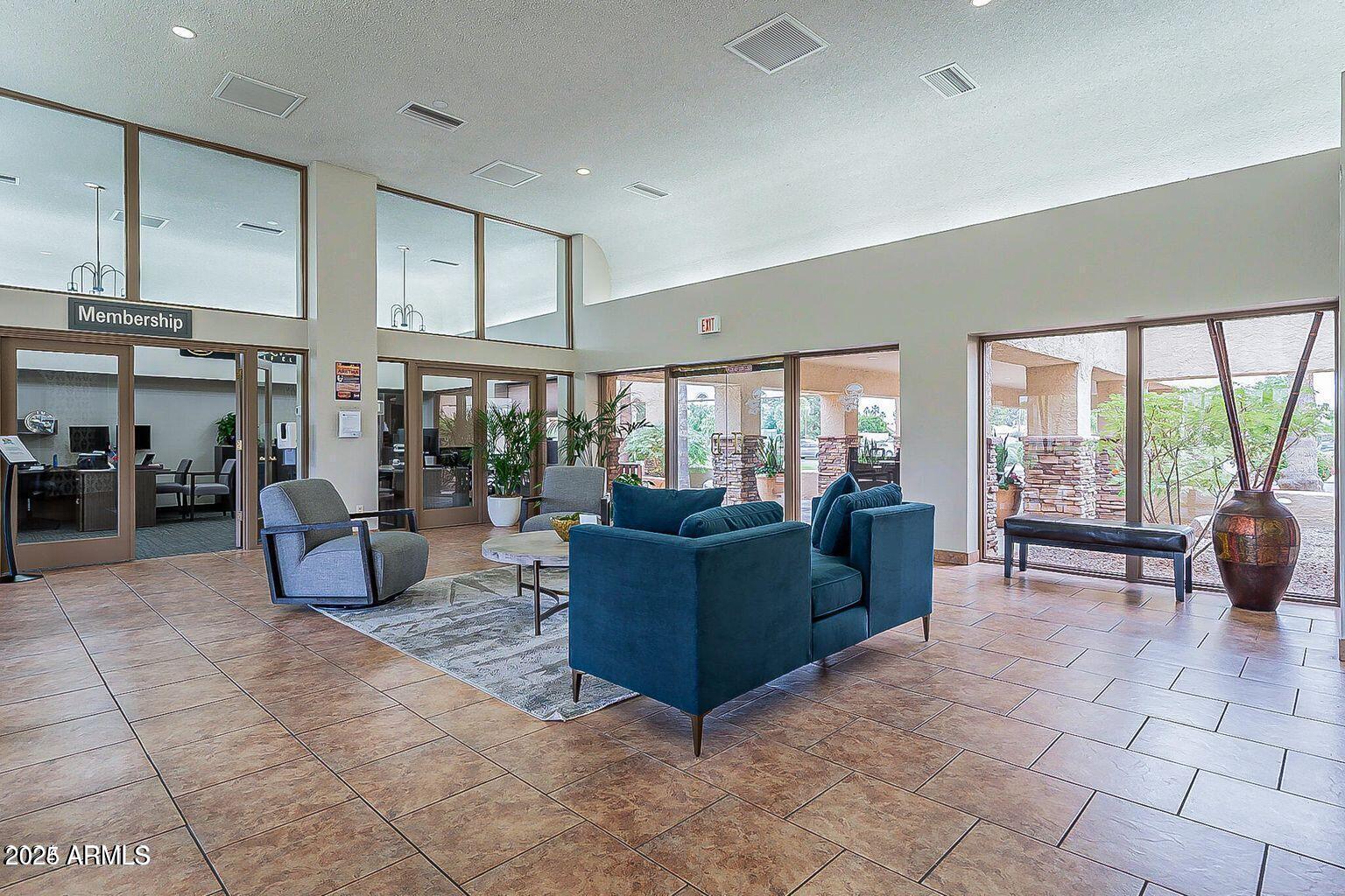 19095 North 97th Lane Peoria, AZ 85382 - Photo 30 of 36 a living room with furniture and a floor to ceiling window