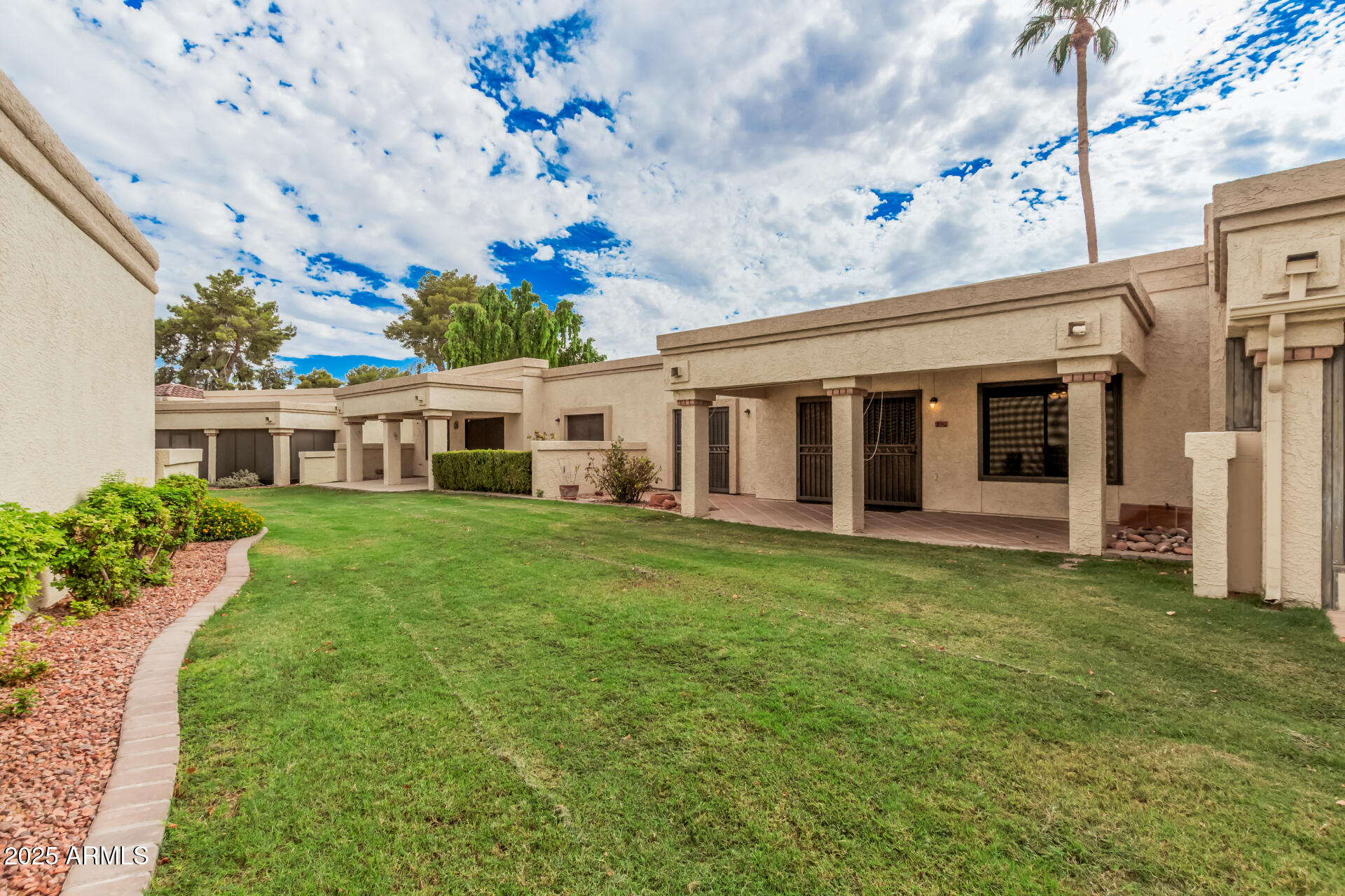 19095 North 97th Lane Peoria, AZ 85382 - Photo 7 of 36 a front view of a house with a garden