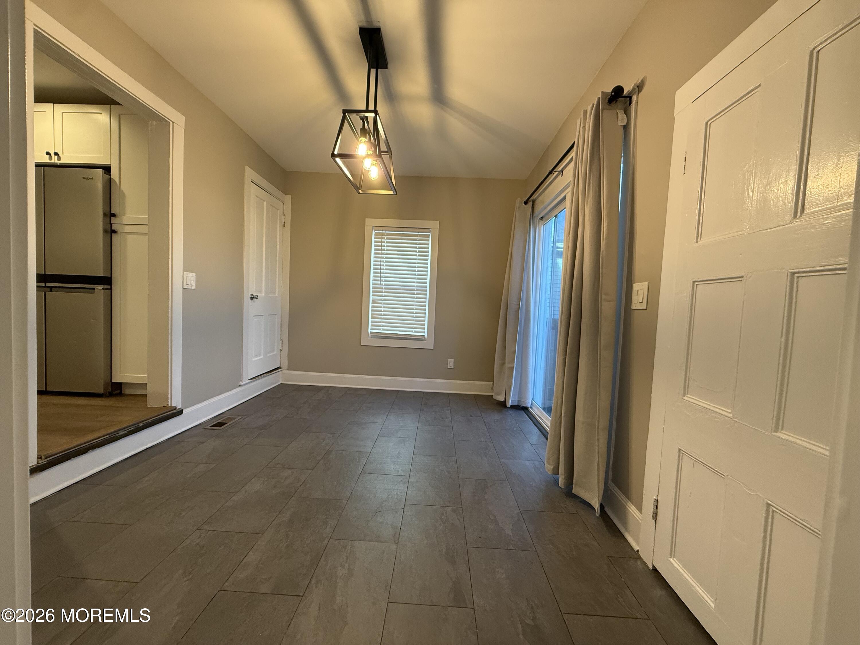 30 Conover Street Freehold, NJ 07728 - Photo 11 of 38 a view of a hallway with wooden floor and chandelier