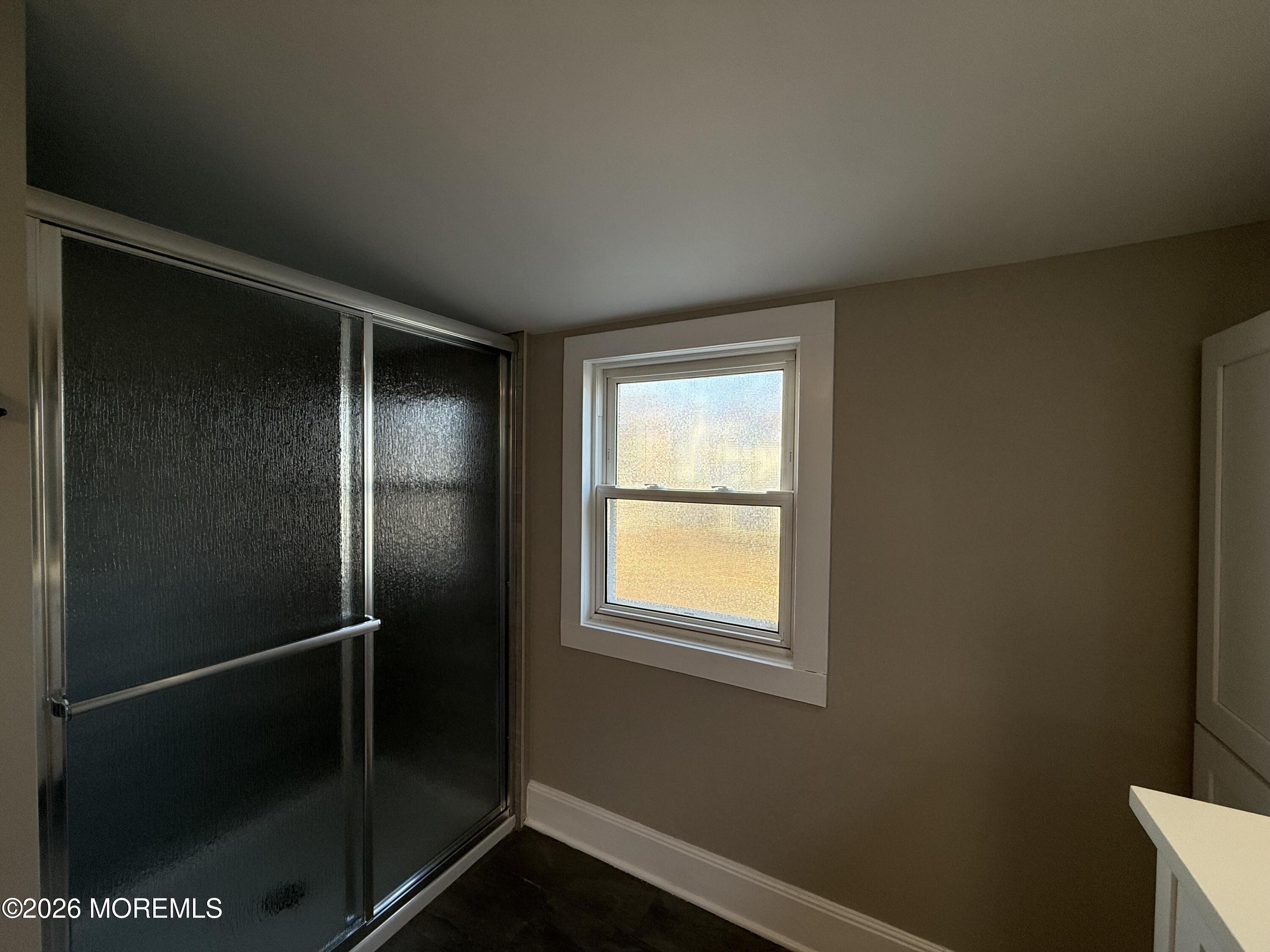 30 Conover Street Freehold, NJ 07728 - Photo 17 of 38 a bathroom with a glass shower door
