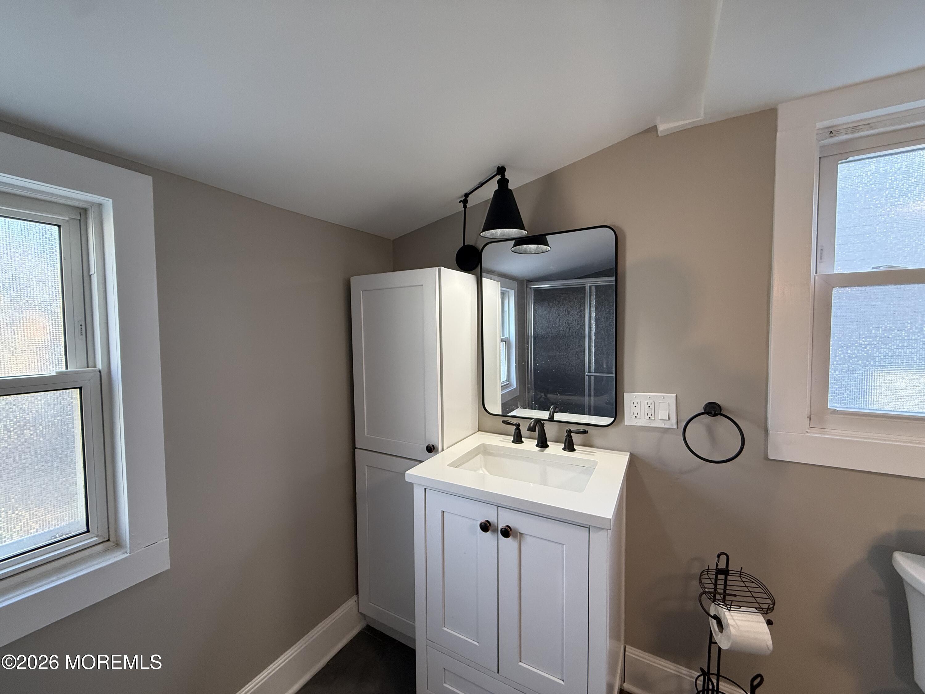 30 Conover Street Freehold, NJ 07728 - Photo 18 of 38 a bathroom with a toilet a sink and mirror