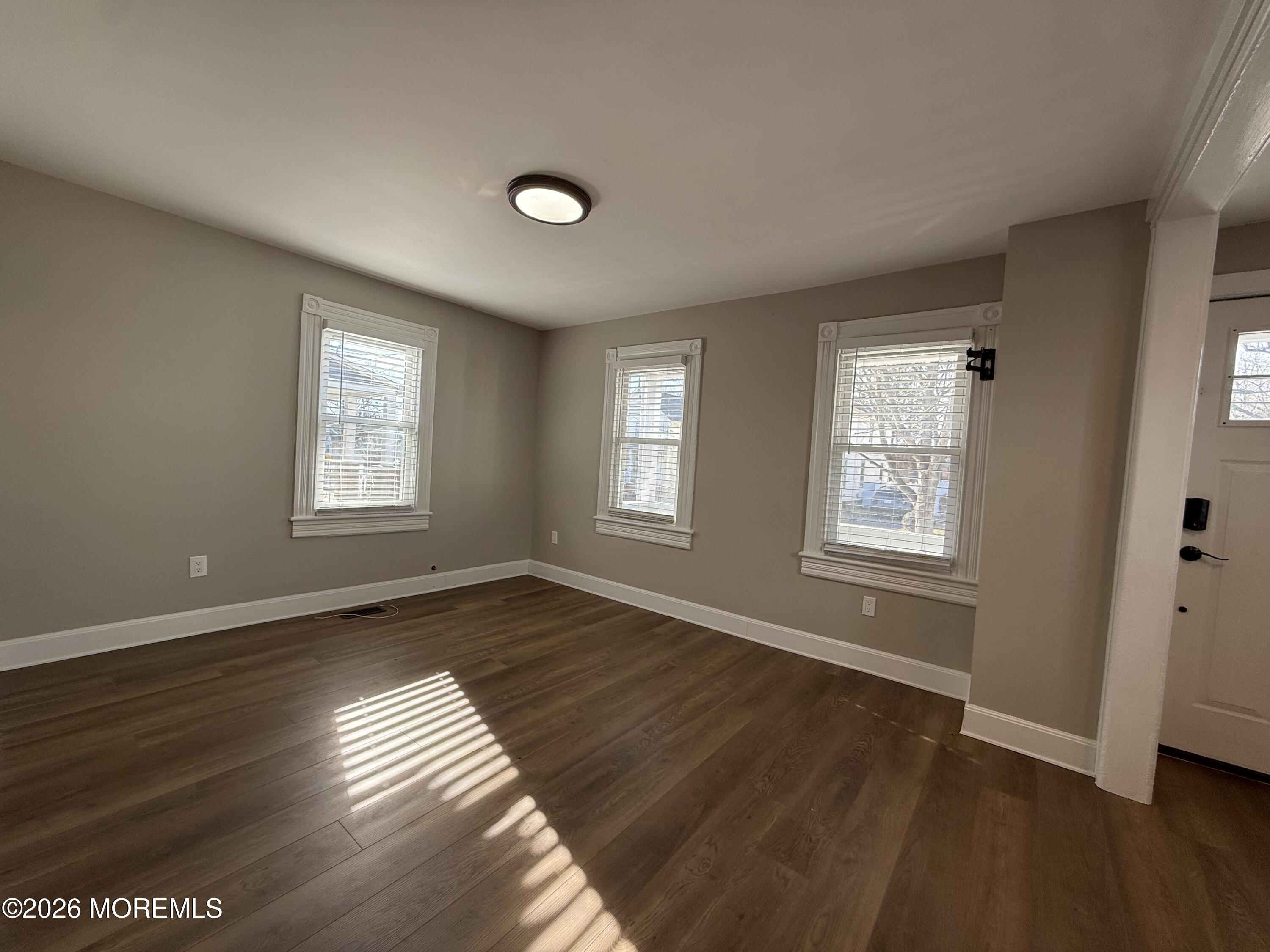 30 Conover Street Freehold, NJ 07728 - Photo 20 of 38 an empty room with wooden floor and windows