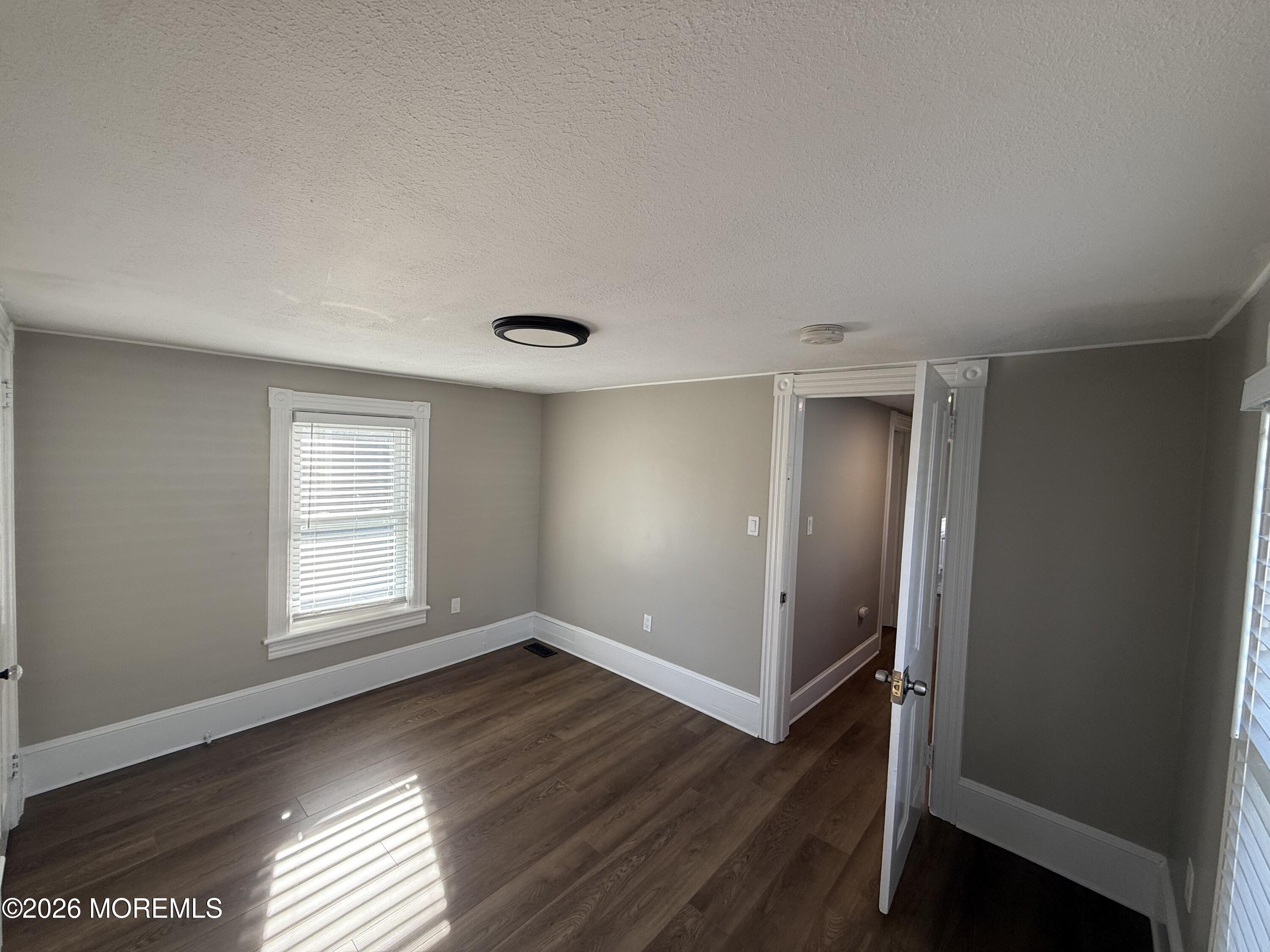 30 Conover Street Freehold, NJ 07728 - Photo 29 of 38 an empty room with wooden floor and windows