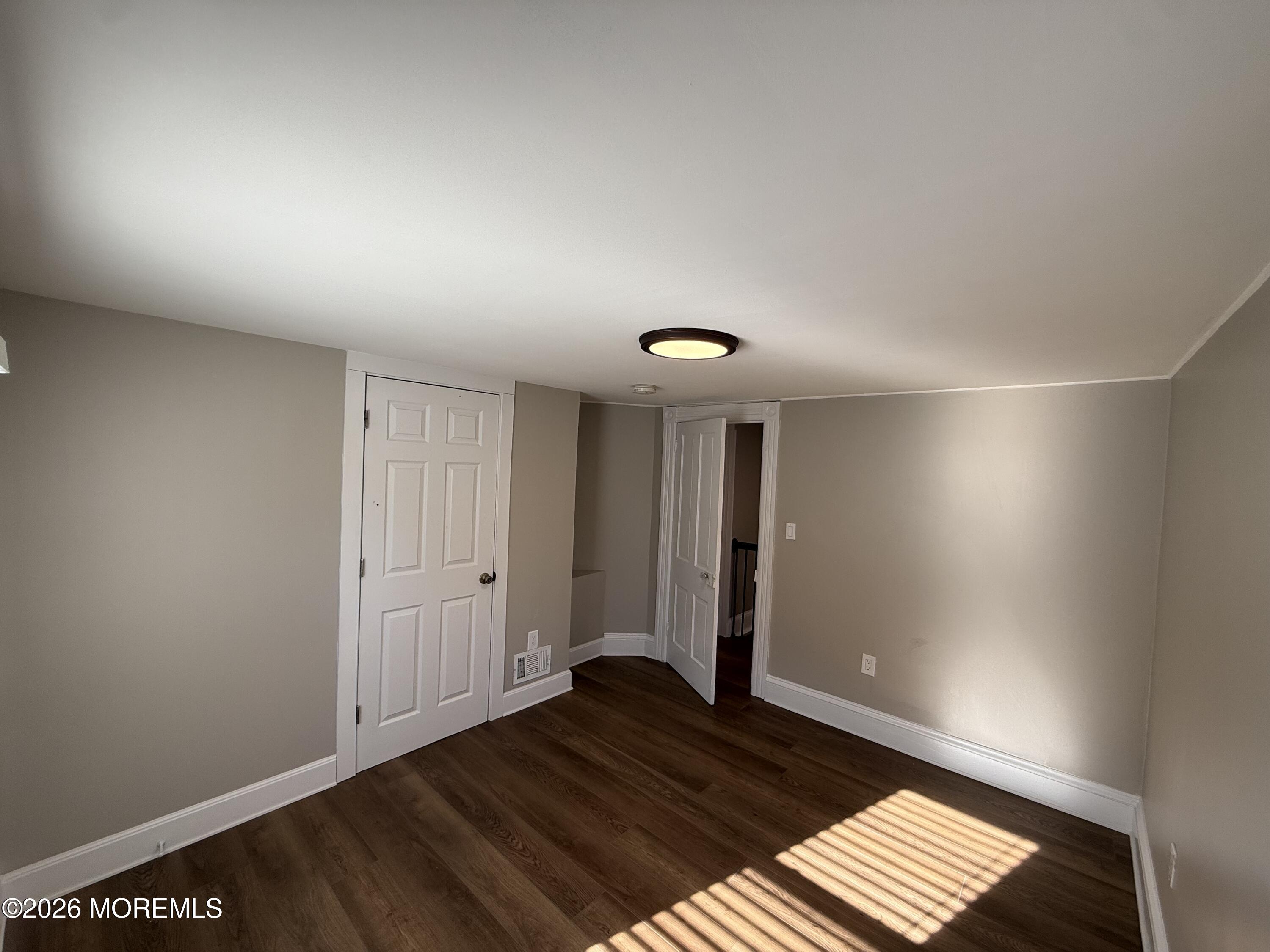 30 Conover Street Freehold, NJ 07728 - Photo 30 of 38 a view of an empty room and wooden floor