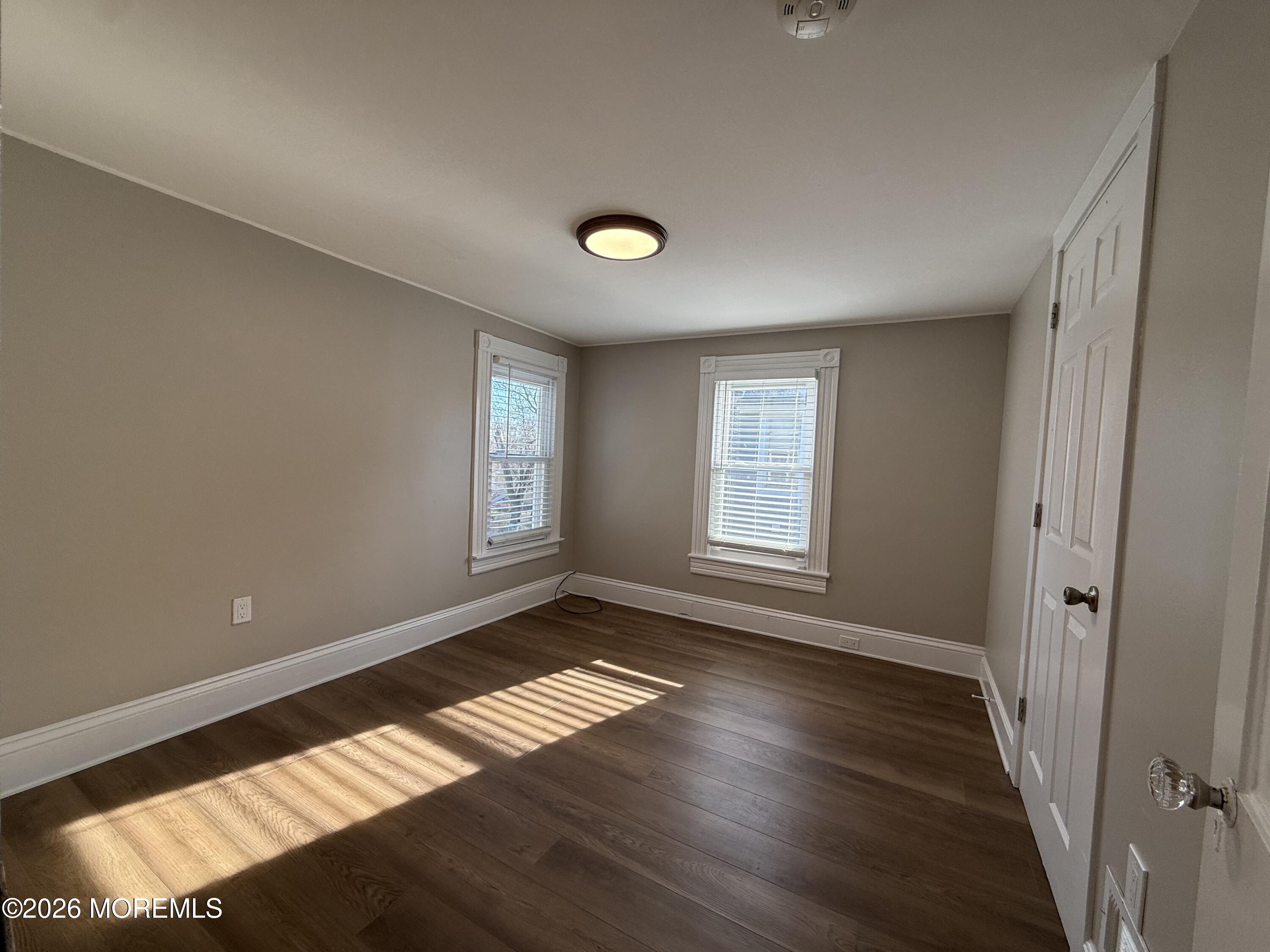 30 Conover Street Freehold, NJ 07728 - Photo 32 of 38 a view of an empty room with wooden floor and a window