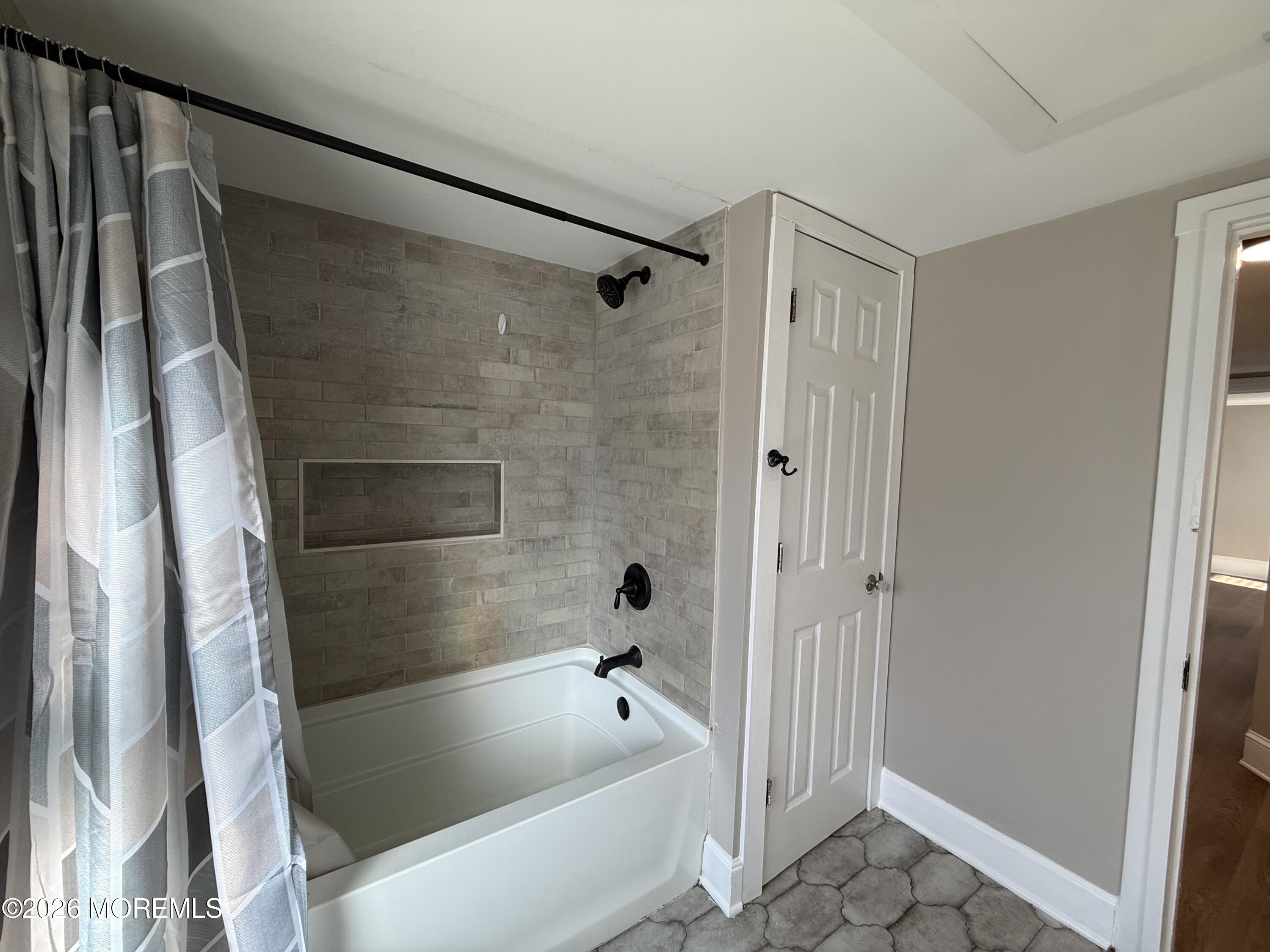 30 Conover Street Freehold, NJ 07728 - Photo 38 of 38 a bathroom with a bathtub and a shower