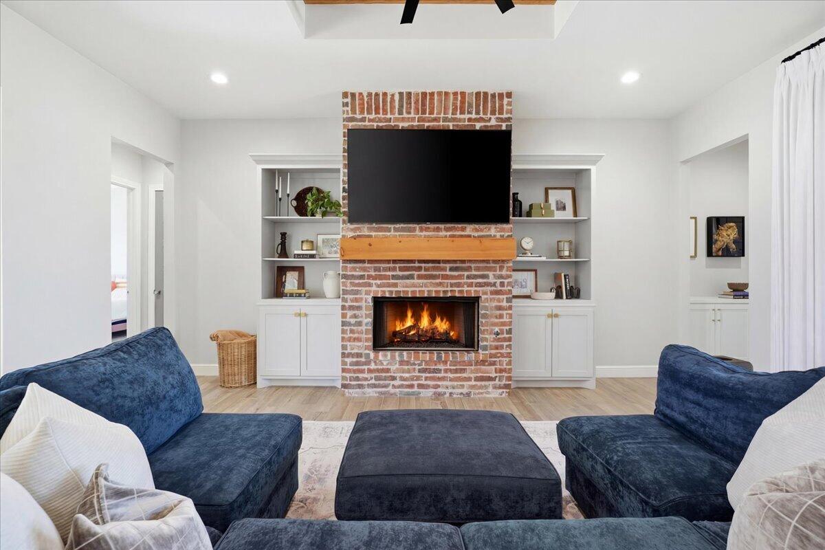 4506 140th Street Lubbock, TX 79424 - Photo 16 of 62 a living room with furniture and a fireplace