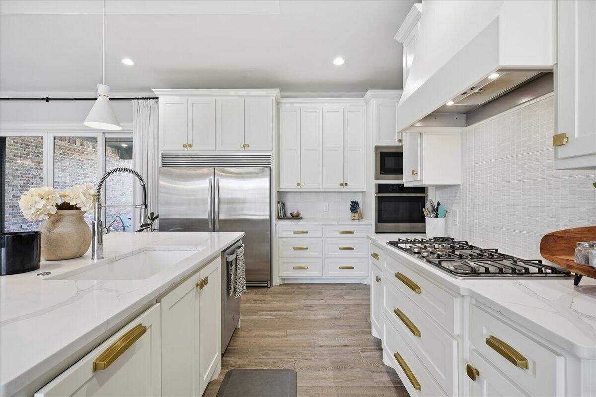 4506 140th Street Lubbock, TX 79424 - Photo 20 of 62 a kitchen with kitchen island a sink appliances and cabinets