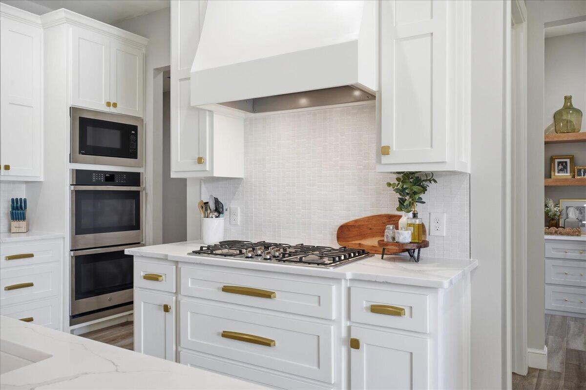 4506 140th Street Lubbock, TX 79424 - Photo 22 of 62 a kitchen with granite countertop a stove and a refrigerator