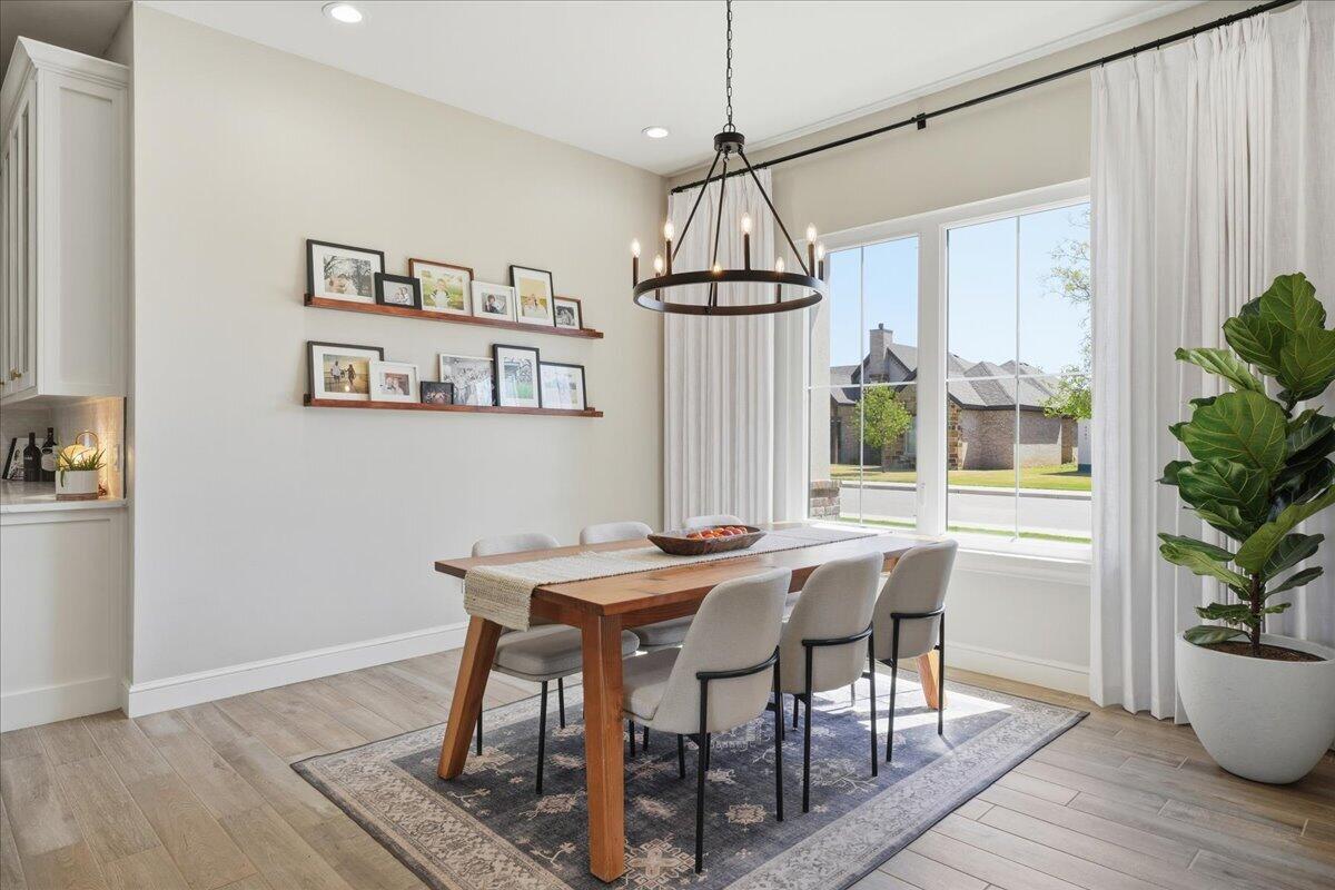 4506 140th Street Lubbock, TX 79424 - Photo 26 of 62 a view of a dining room with furniture window and wooden floor