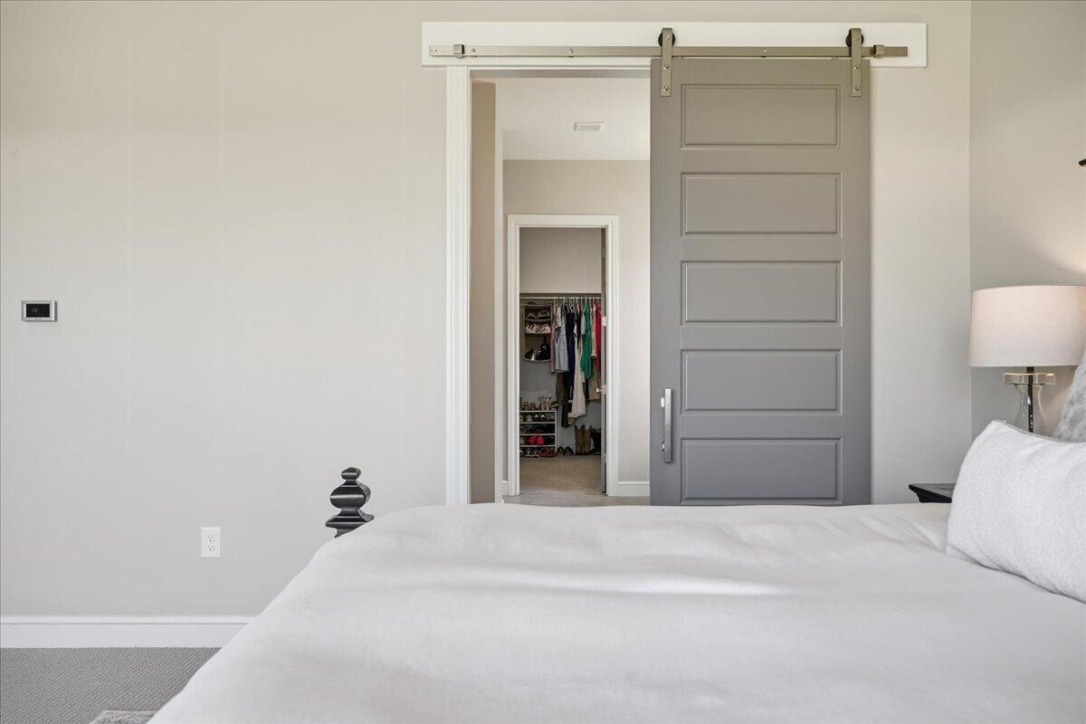 4506 140th Street Lubbock, TX 79424 - Photo 30 of 62 a bedroom with a bed and a bathroom