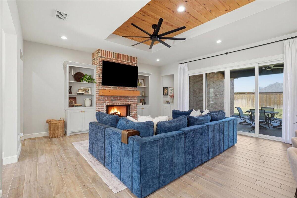 4506 140th Street Lubbock, TX 79424 - Photo 3 of 62 a living room with furniture a flat screen tv and a fireplace