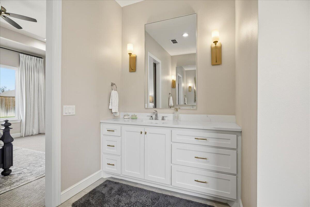 4506 140th Street Lubbock, TX 79424 - Photo 33 of 62 a bathroom with a double vanity sink and a mirror