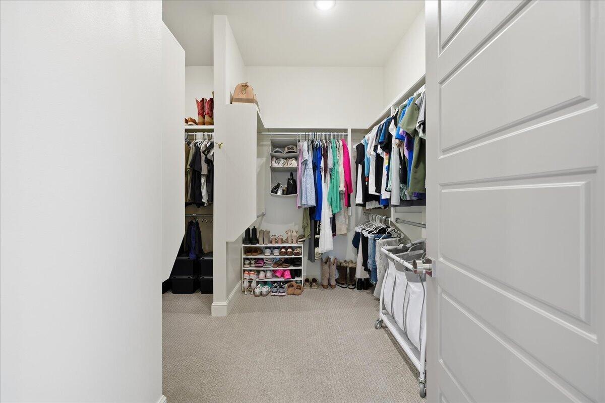 4506 140th Street Lubbock, TX 79424 - Photo 36 of 62 a view of walk in closet with clothes and shoes