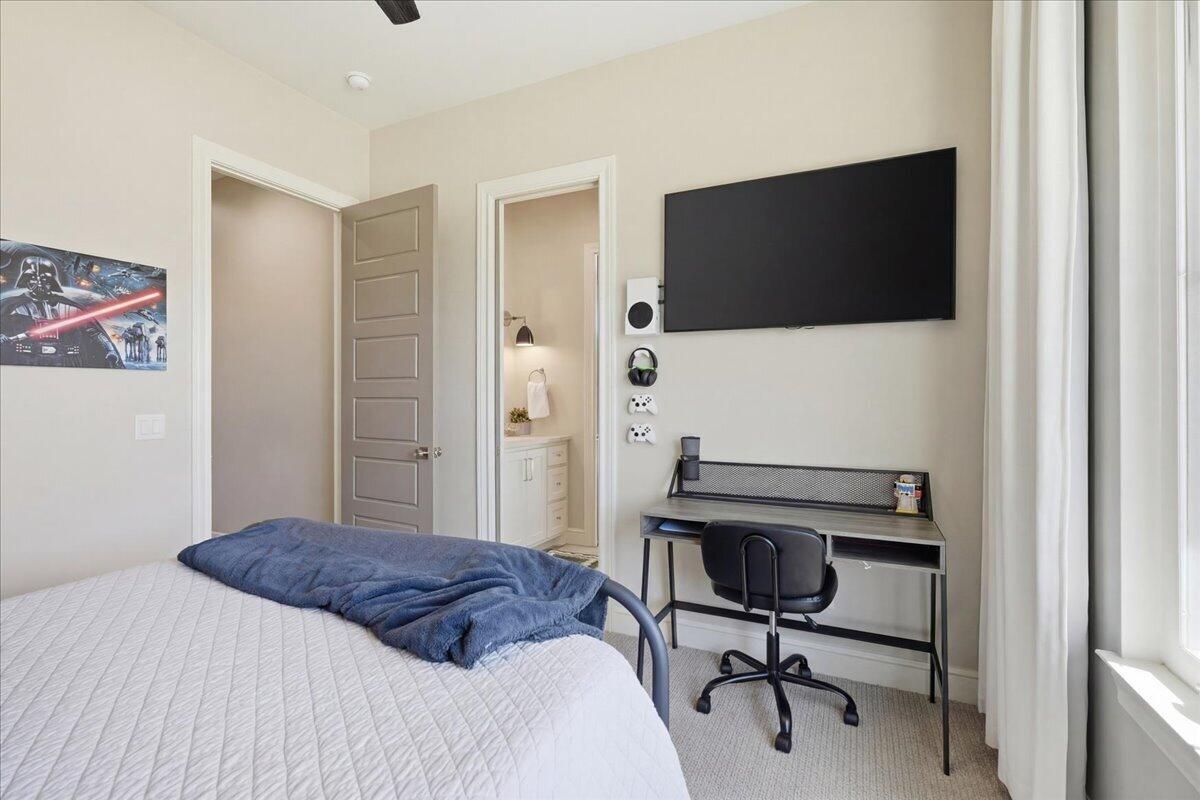 4506 140th Street Lubbock, TX 79424 - Photo 43 of 62 a bedroom with a bed and a flat screen tv