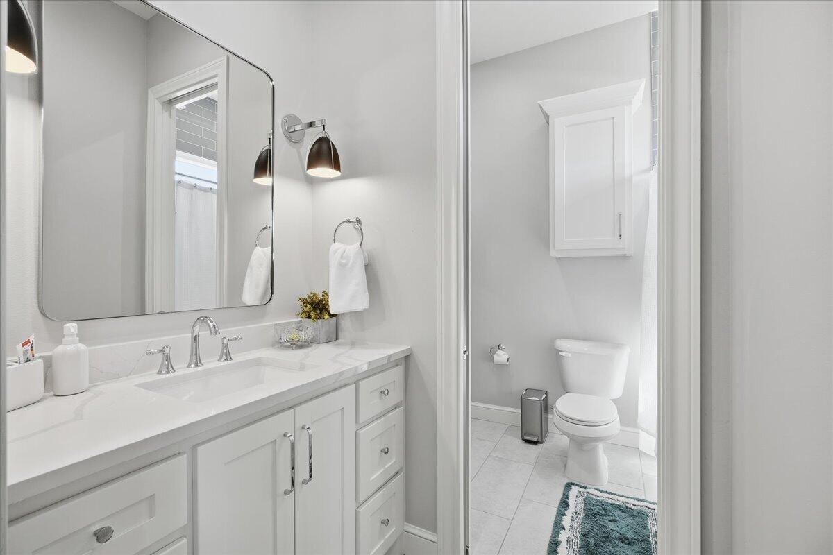 4506 140th Street Lubbock, TX 79424 - Photo 44 of 62 a bathroom with a toilet sink and mirror