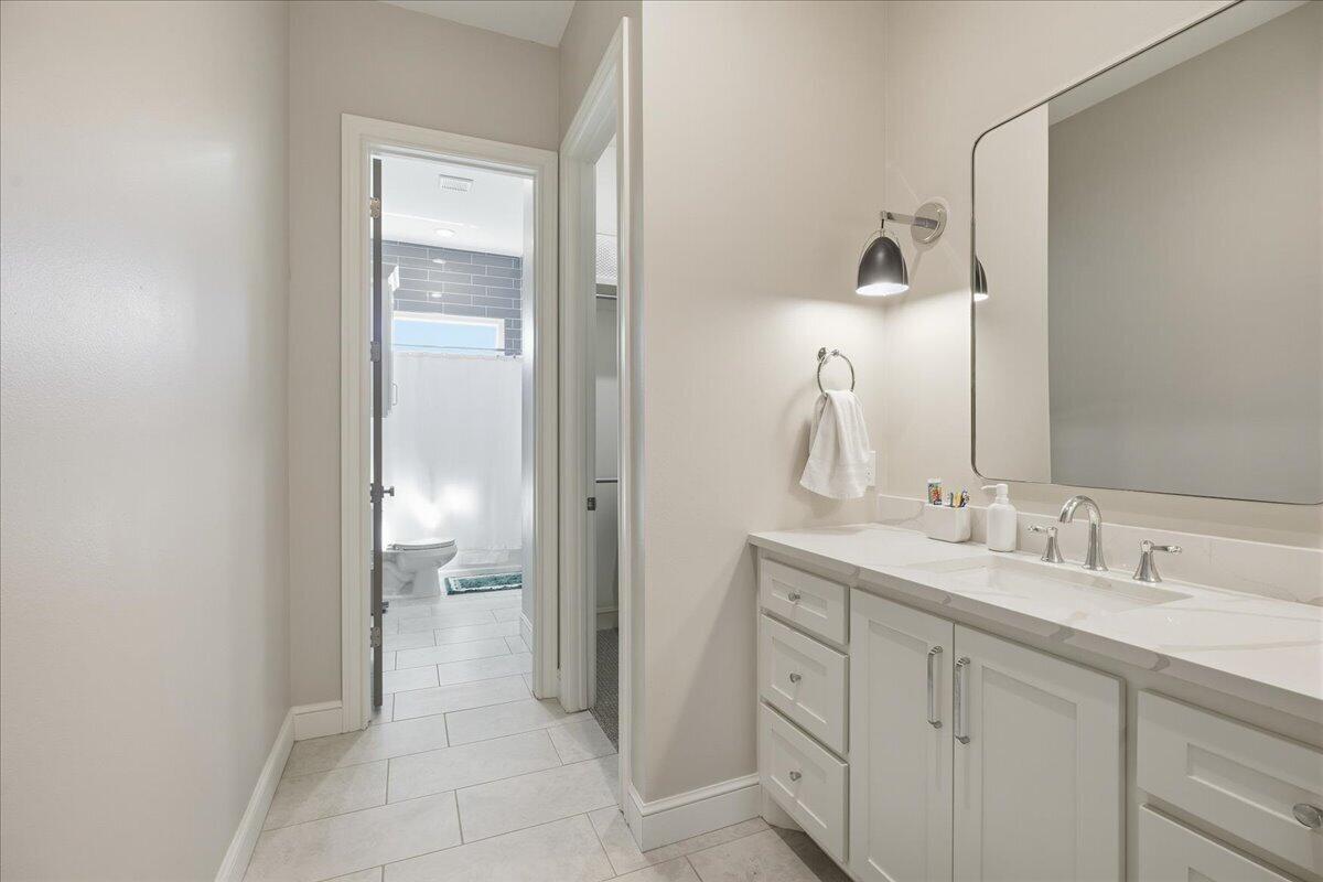 4506 140th Street Lubbock, TX 79424 - Photo 47 of 62 a spacious bathroom with a double vanity sink and a mirror
