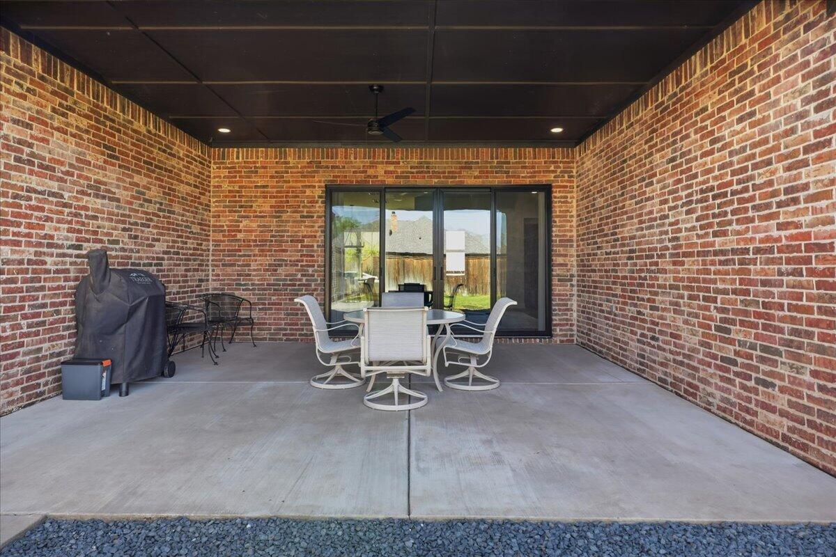 4506 140th Street Lubbock, TX 79424 - Photo 53 of 62 a view of a patio with table and chairs and potted plants