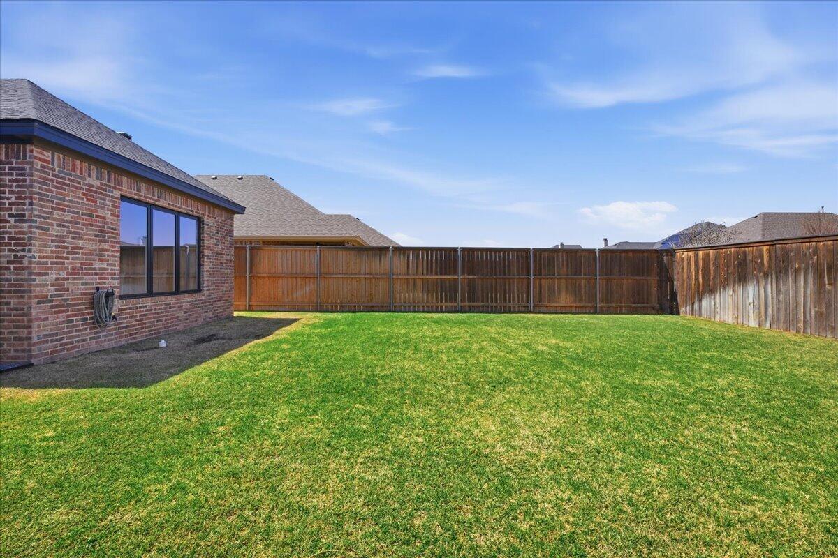 4506 140th Street Lubbock, TX 79424 - Photo 54 of 62 a view of a backyard with a garden and plants