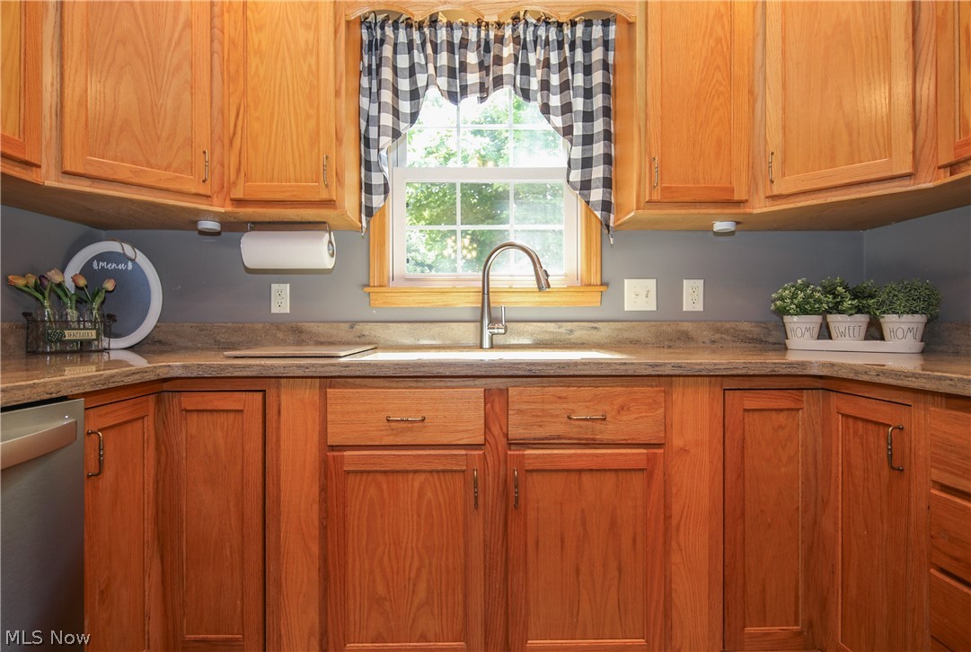 38610 Spiedel Town Road Bethesda, OH 43719 - Photo 10 of 33 Kitchen with light stone countertops, sink, and stainless steel dishwasher