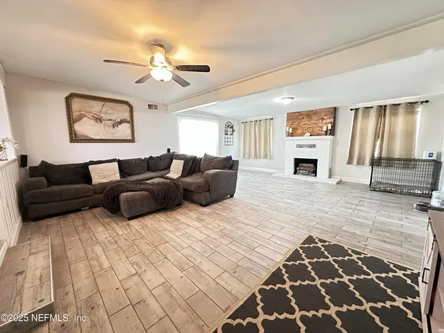 a living room with furniture and a fireplace