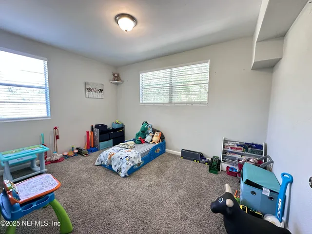 a bedroom with furniture and a wooden floor