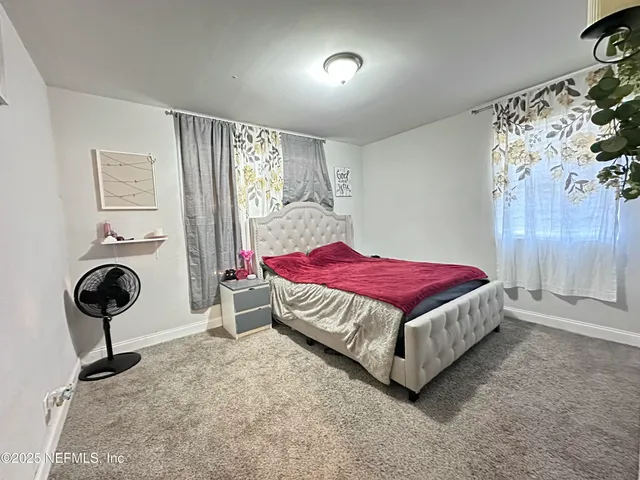 a bedroom with a bed and a chair