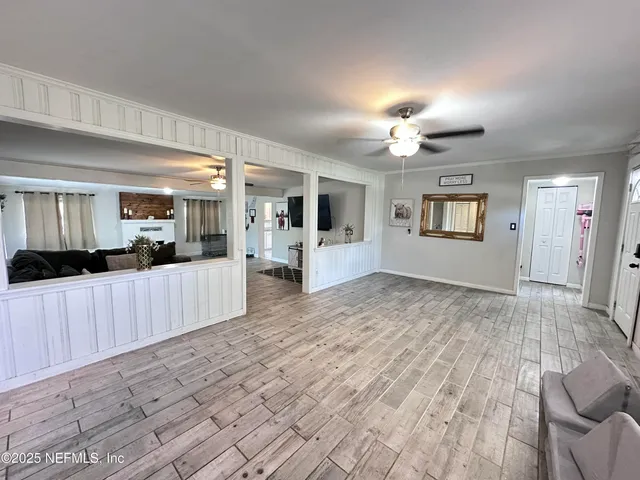 a view of a kitchen with kitchen island granite countertop a refrigerator stove top oven with a sink
