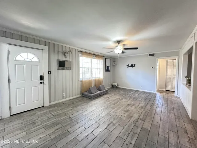 wooden floor in an empty room with a window