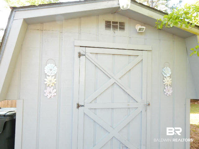 548 Escambia Loop Lillian, AL 36549 - Photo 11 of 16 Shed with workshop & washer & dryer & AC