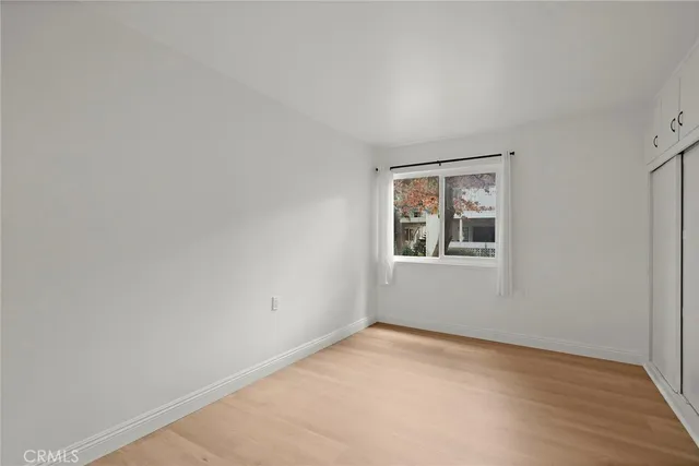 a view of an empty room with closet area