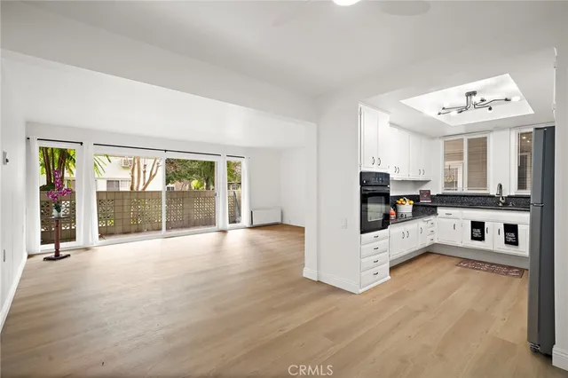 a view of a street with a cars park side of the road