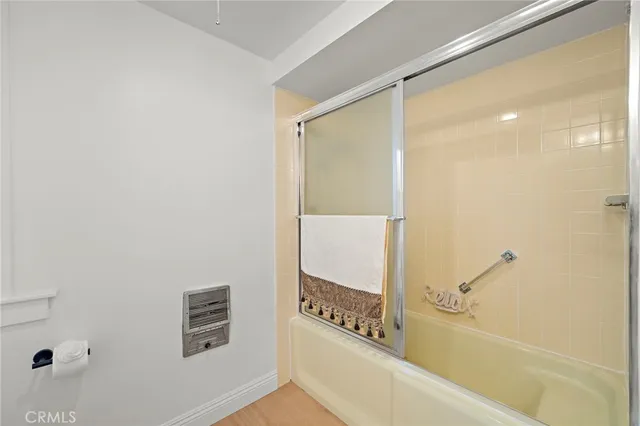 a bathroom with a granite countertop double vanity sink and a mirror