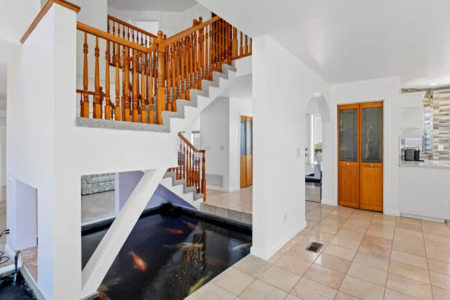 a living room with granite countertop furniture a fireplace and large windows