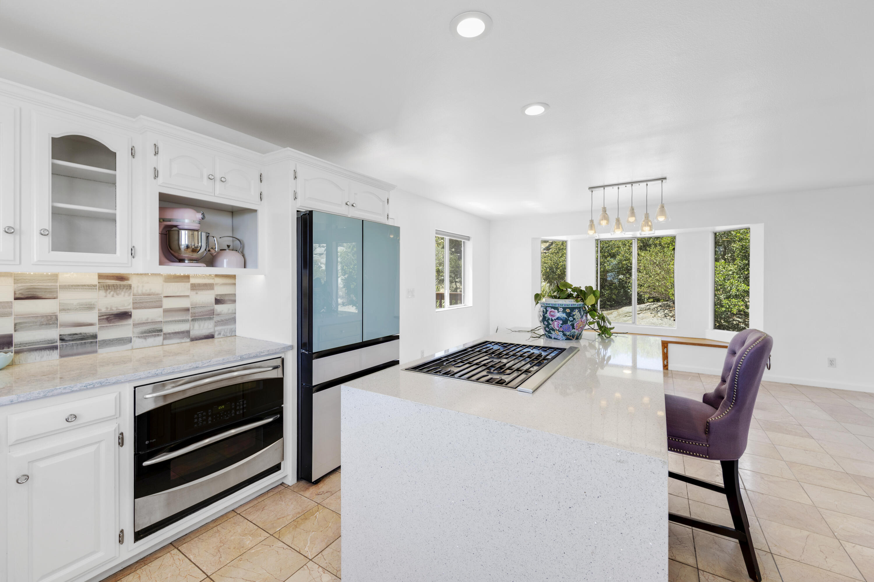 60425 Santa Rosa Road Mountain Center, CA 92561 - Photo 24 of 67 a kitchen with stainless steel appliances kitchen island granite countertop a stove a sink a refrigerator and chairs