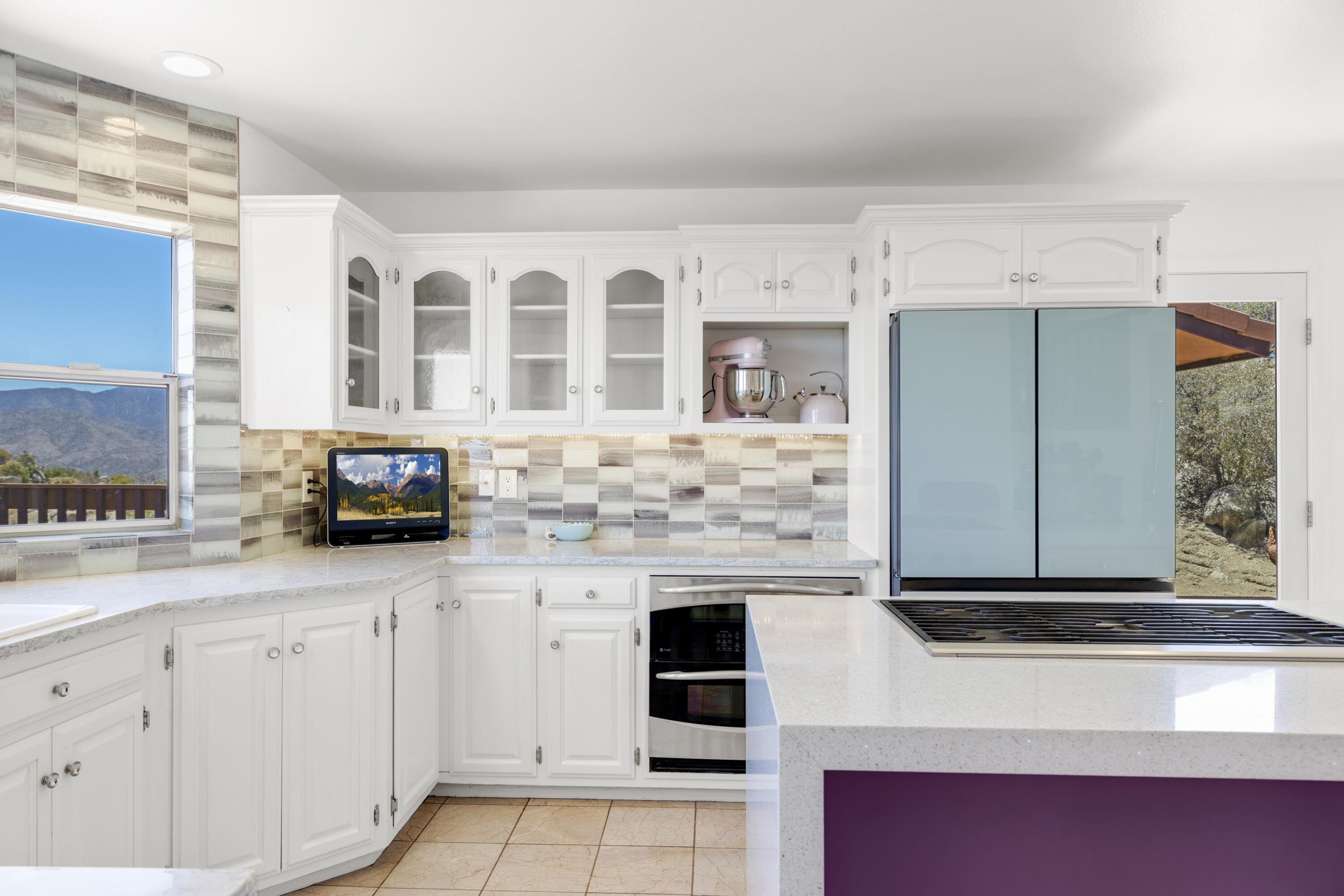 60425 Santa Rosa Road Mountain Center, CA 92561 - Photo 25 of 67 a kitchen with stainless steel appliances white cabinets and a counter top space