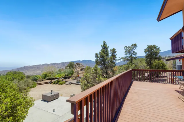 a bathroom with a granite countertop sink a bathtub and window
