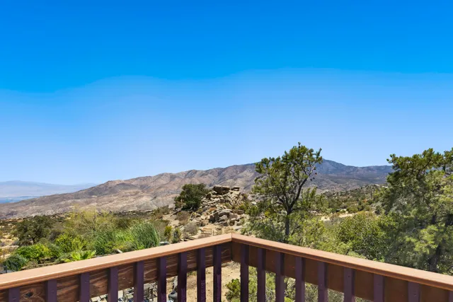 an empty space with wooden floor and a ceiling fan